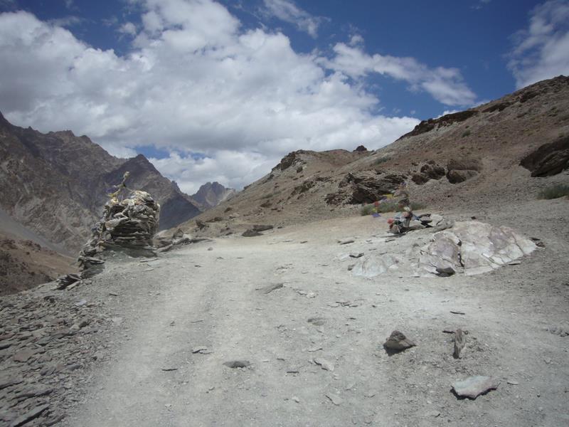 Mounds of stones and prayer flags dot the path along the mountain.